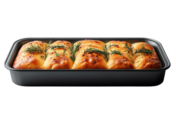 Freshly baked bread rolls topped with herbs in a black tray, perfect for a cozy meal.