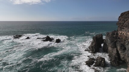 the ocean waves giving wonderful shapes to the cliffs