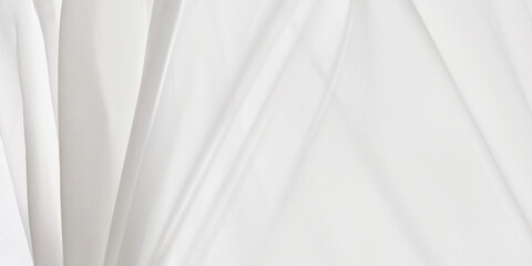 Close-up, high-key image showcases the soft, flowing texture of white, semi-transparent fabric. Material is draped and folded, creating gentle waves and delicate creases. Clean and minimalistic