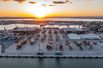 Aerial view to new container unloading terminal of port of Burgas, Bulgaria at sunset. Logistics...