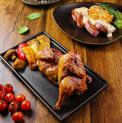 Grilled chicken served with roasted vegetables and rice on wooden table