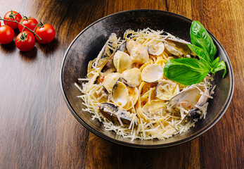 Delicious seafood pasta topped with fresh basil and cheese in a cozy restaurant