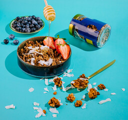 A colorful display of granola topped with strawberries and coconut flakes