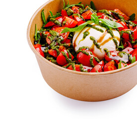 Fresh burrata salad with tomato, basil, and creamy cheese served in a bowl