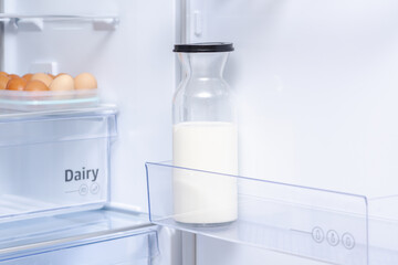 Open Refrigerator with Eggs and Milk