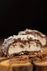 halved sweet marshmallows in chocolate sprinkled with coconut chips, sweet dessert marshmallows in...