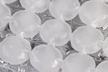 white ice in bags for freezing water, frozen water in special bags for making beautifully shaped...