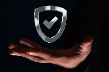 Image of a hand holding a digital shield icon, symbolizing data security and protection.