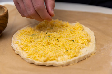 cheese tortilla made of yeast dough and grated cheese, thinly rolled yeast dough sprinkled with...
