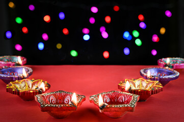 Colorful diwali light decoration on red background.