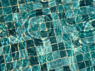 High-quality photo of turquoise pool tiles underwater. Perfect for summer, travel, or vacation themes.