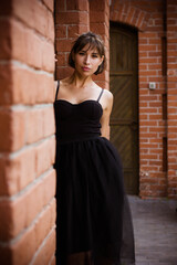 portrait of a young brunette woman in a black dress