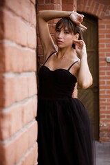portrait of a young brunette woman in a black dress
