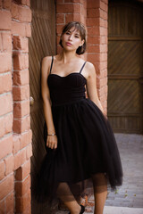 portrait of a young brunette woman in a black dress
