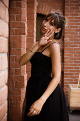 portrait of a young brunette woman in a black dress