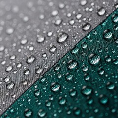 Close up view of water drops on waterproof fabric texture. Rain repellent material surface with clear beads for outdoor gear concept.