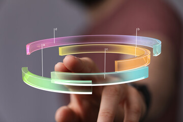 Person interacting with a transparent 3D data chart, showcasing innovative technology and data analysis.