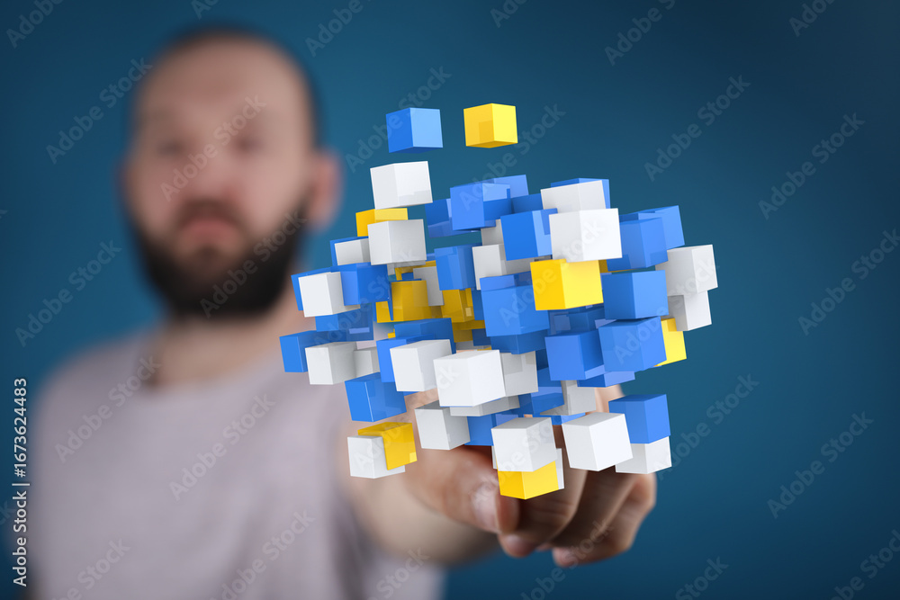 Poster abstract image of a man holding a cluster of colorful cubes, symbolizing data, technology, or innova