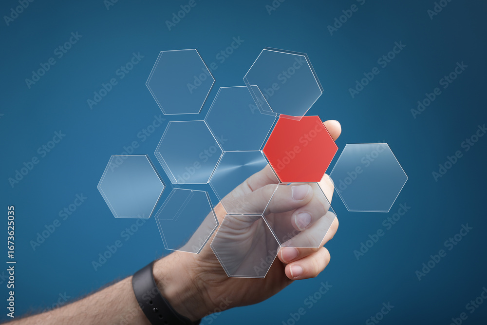 Aufkleber abstract image of a hand selecting a red hexagon from a network of transparent hexagons. ideal for t