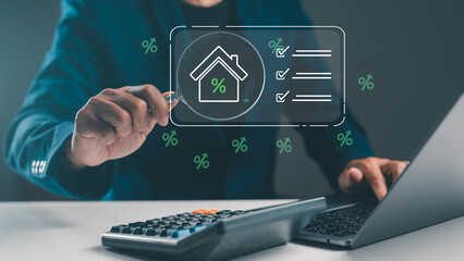 A person analyzes a financial document related to real estate, using a calculator and a laptop, with percentage symbols and a house icon displayed digitally.