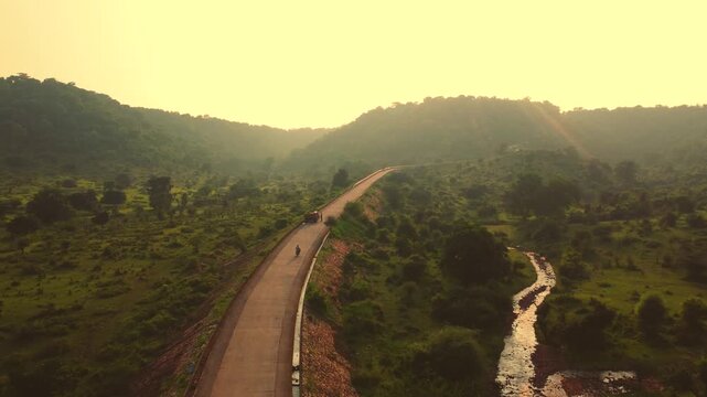 Chasing shot of bike moving on a elevated hill road in madhya pradesh india