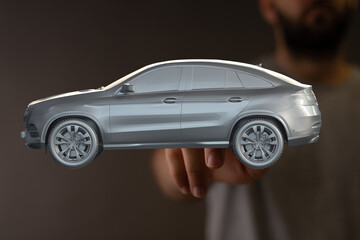 3D rendered image of a luxury SUV car model held in a person's hand. Perfect for automotive,...
