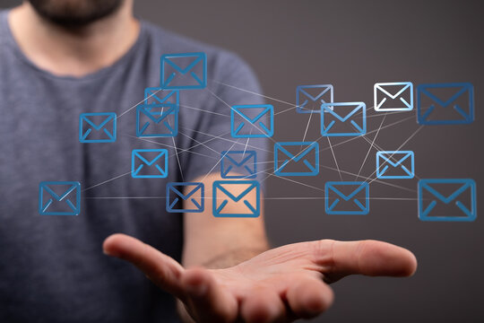Image depicts a man's hand showcasing a network of interconnected email icons, symbolizing global communication and secure data exchange.