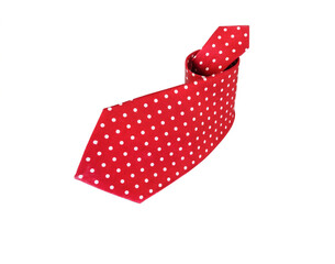 Obraz premium Rolled red silk polka dot necktie isolated on white background.