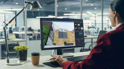 Female Interior Designer Using Advanced 3D Modeling Software on a Desktop Computer to Create a...