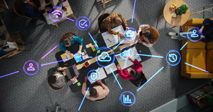 Diverse Team Discussing Internet Software Tools, Online Services and Apps. Top Down Shot with Animated Holographic Icons Representing Cloud Storage, Privacy, Data Protection, Emailing, Reporting