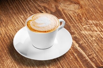 Coffee drink in cup on table in cafe