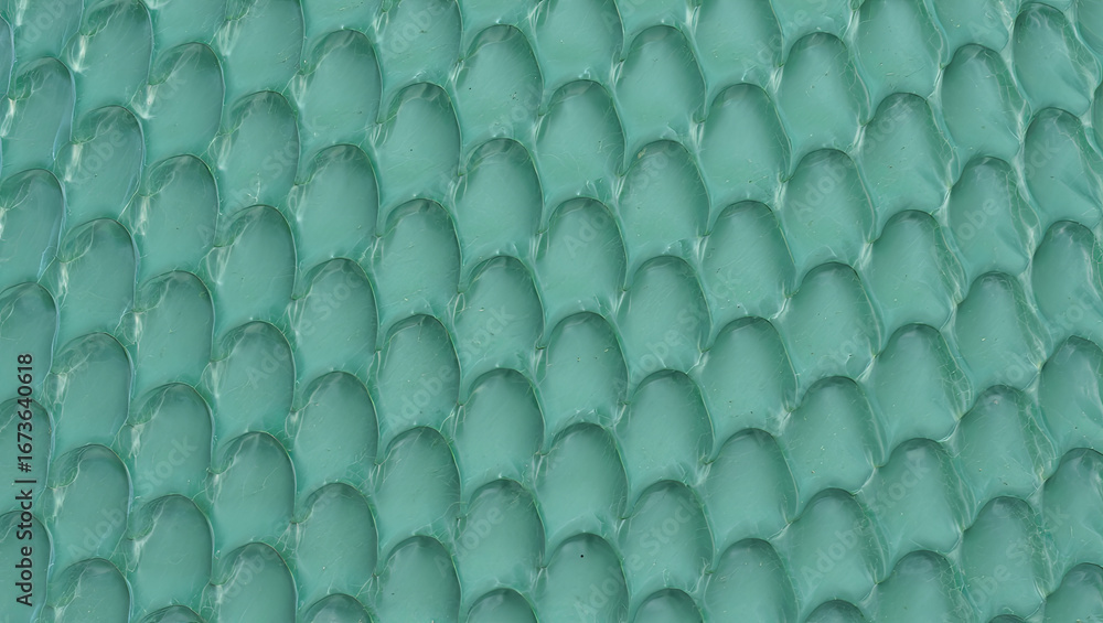 Poster The image features a close-up of a textured surface displaying overlapping scales in a vibrant turquoise color, illuminated softly. This artistic design highlights intricate details