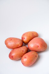 Selective focus of red potato on white background