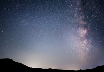 Beautiful bright Milky Way galaxy  over the hill.  Night sky astronomical background. 