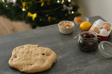 Brown raw dough ready for adding filling in a cozy kitchen in a cozy atmosphere. Traditional baking Christmas stollen