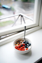 Healthy Morning Indulgence Fresh Berries and Nuts Breakfast Bowl by the Window for a Perfect Nutritious Start