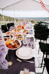 Elegant outdoor dining setup with gourmet food overlooking a scenic view