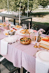 Elegant outdoor dining setup with an array of delicious food and beautiful decor