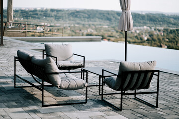 Stylish outdoor seating area with modern furniture overlooking a scenic landscape