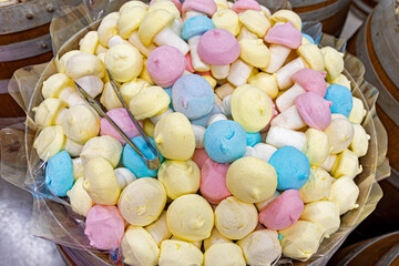 Colorful marshmallow mushrooms in bulk candy bin. Pastel-colored marshmallow candies shaped like...