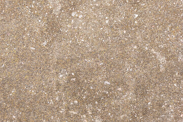Concrete texture. Pebbles of different colors and signs of aging are visible.