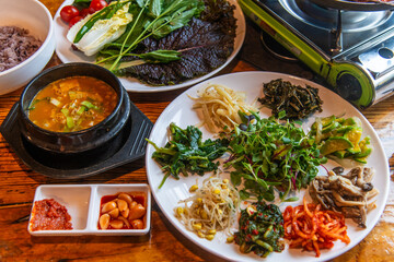 traditional Korean dinner table with various foods including ssambap