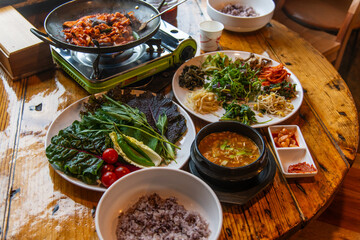 traditional Korean dinner table with various foods including ssambap