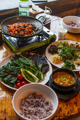 traditional Korean dinner table with various foods including ssambap