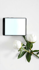 Fototapeta premium Tablet with blank screen and white peonies on white background 