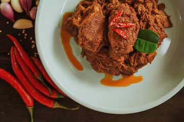 Spicy and tender beef rendang served on a plate with a mix of natural spices. Authentic Indonesian food (3)