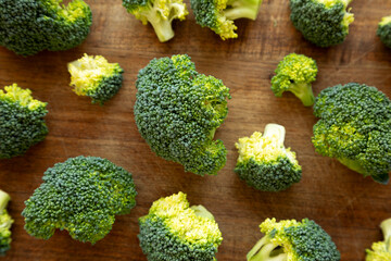 Raw Organic Green Broccoli on a Wooden Board, top view.