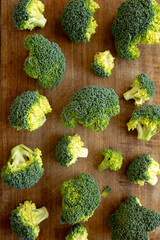 Raw Organic Green Broccoli on a Wooden Board, top view. Flat lay.