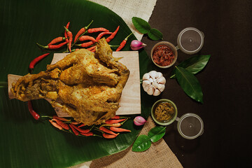 whole free-range chicken cooked with natural spices and served on a banana leaf with onions and chili sauce. Traditional Javanese dish food (2)
