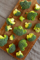 Raw Organic Green Broccoli on a Wooden Board, top view.